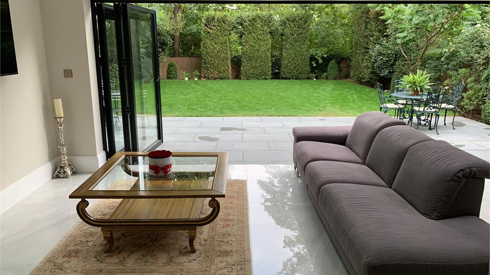 The garden room, with the bi-fold doors open to the terrace and lawn